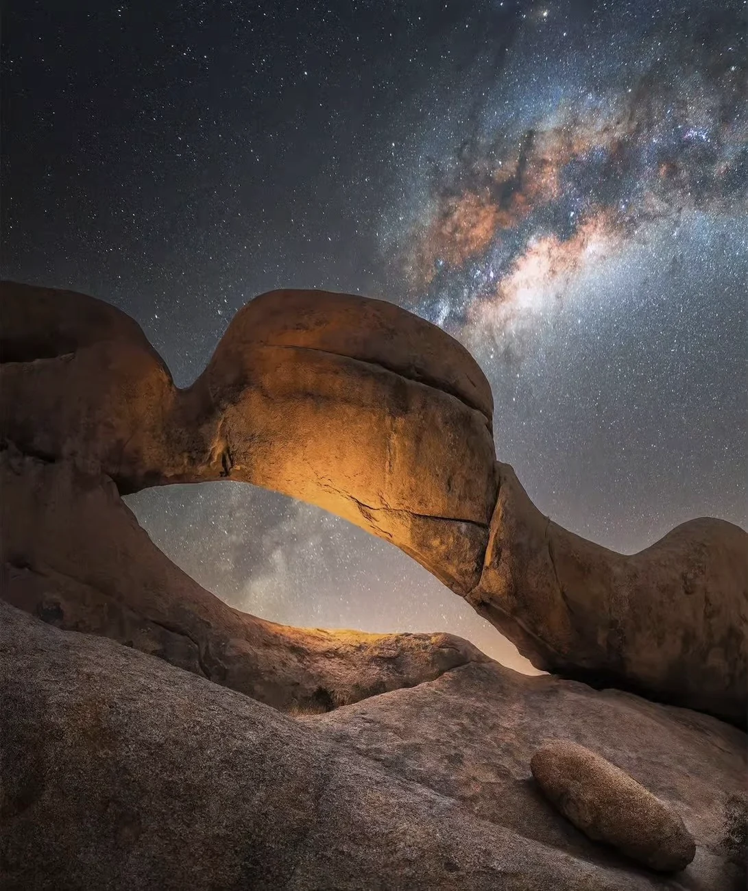 Long-exposure night photograph of the Spitzkoppe Rock Arch beneath the Milky Way